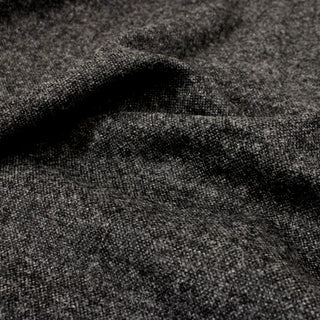close-up of charcoal wool tweed fabric showcasing weave and texture