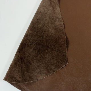 close-up of two sides of a chocolate colored lambskin, one a leather face and the backside a soft suede