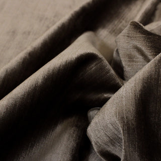 close-up of a rich brown upholstery velveteen fabric, demonstrating the sheen and color variation of the pile