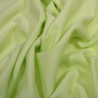 close-up of citron interlock knit jersey fabric, detailing the smooth knit face