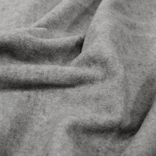 close-up of light grey wool-blend felted fabric, detailing its soft face