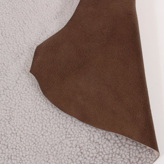 front and back of coconut white colored shearling and husk brown leather hide piece