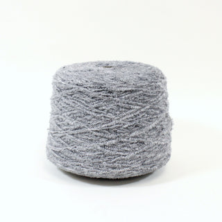 large cone of coin grey colored eyelash yarn, fuzzy in texture