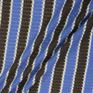 three diagonal lines draped of a brown, white, and cornflower blue striped novelty-knit lightweight fabric