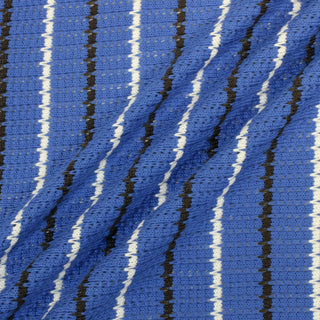 three diagonal lines draped of a brown, white, and cornflower blue striped novelty-knit lightweight fabric