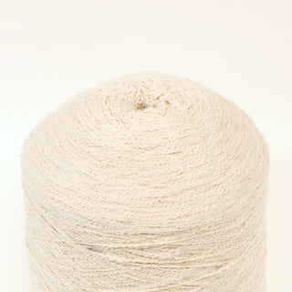 close-up of a large cone of cream colored slub yarn
