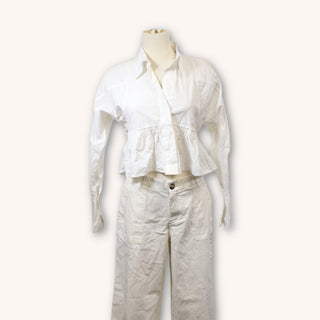 white cropped peplum blouse with collar on a mannequin with off-white pants