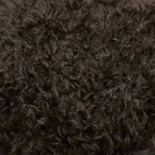 face of a long-fur shearling hide with a curly texture to it in a dark clove brown