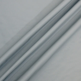 silk crepon fabric in a soft duck egg blue color with three diagonal lines arranged across its surface to demonstrate the subtle drape