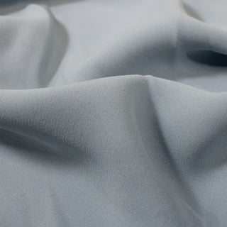 close-up of duck egg blue colored silk crepon fabric, detailing the weave structure and matte face