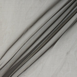 dusty cocoa colored silk organza fabric, manipulated into three diagonal peaks to show the stiff drape, sheer matte hand, and lightweight quality