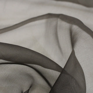 close-up of a dusty cocoa colored silk organza fabric, detailing the plainweave and lightweight, sheer quality