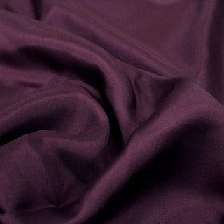close-up of eggplant silk fabric, detailing its twill weave and subtly shiny surface