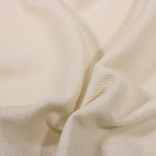 close-up of an off-white colored textural knit jersey fabric, detailing the knit structure 