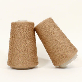 two small cones of fawn brown ultra-fine yarn