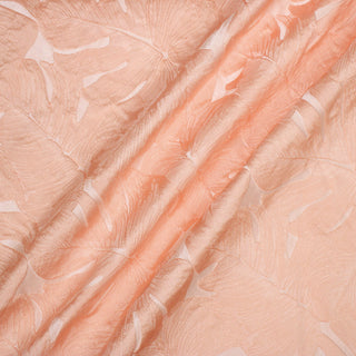 flamingo pink brocade fabric with large leaf motifs overlapped across its weave, three diagonal lines across the surface to show the drape and fabric weight