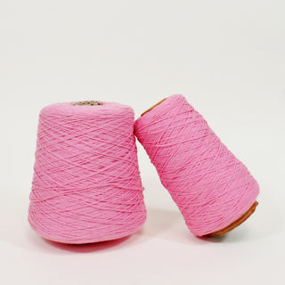 two large cones of midweight core yarn in flamingo pink color
