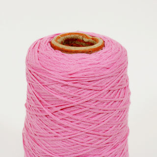 close-up of a small cone of flamingo pink colored midweight yarn