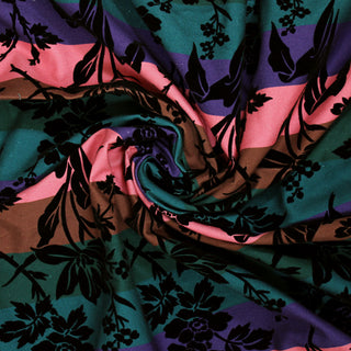 Swirl of a flocked multi stripe fabric, detailing the surface shine and drape.