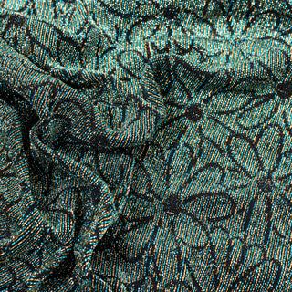 close-up of teal, gold, and black floral metallic knit jersey fabric, detailing its motif and knit structure