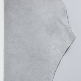 front and back of a lambskin leather hide that's dyed light fog grey and sueded on the backside