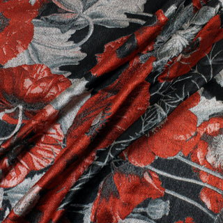 three diagonal lines draped of a red, black, and silver silk floral jacquard fabric