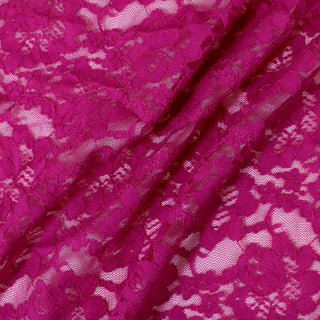 three diagonal lines draped of a pink stretch lace floral mesh fabric, demonstrating its sheer nature, drapeability, and lightweight hand