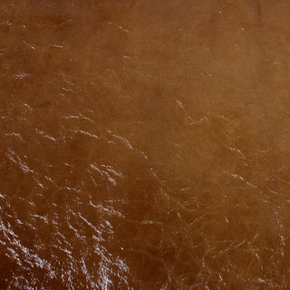 face of a glossy finished crinkle textured cow leather hide in a reddish brown color