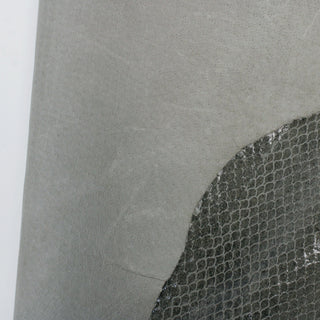 front and back of a laurel green colored calfskin hide, one side embossed with a snakeskin print and covered in a glossy sheen, and the back a sanded leather texture