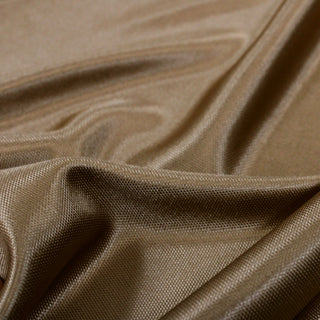 close-up of gold interlock viscose jersey fabric with shiny face and noticeable knit texture