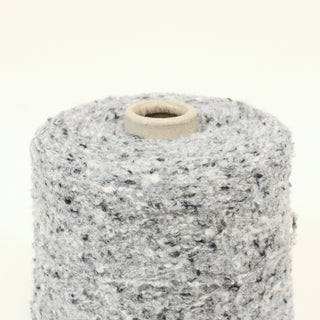 close-up of a cone of multicolor grey boucle yarn
