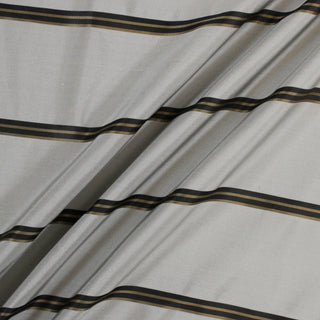 three diagonal lines draped of a silver colored silk taffeta fabric with horizontal black and gold stripes