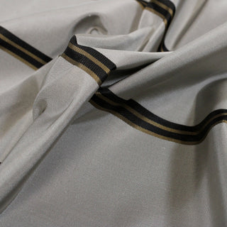 close-up of a grey silk taffeta fabric with gold and black stripes