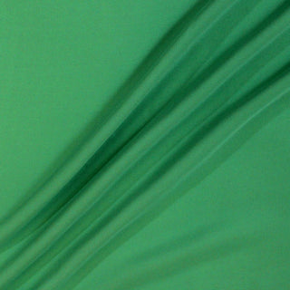 three diagonal lines arranged with a piece of gumby green colored silk chiffon fabric, demonstrating its lightweight hand and drape