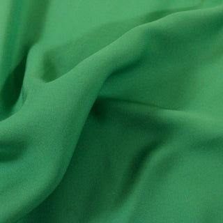 close-up of gumby green silk chiffon fabric, detailing its weave structure and matte hand