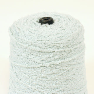 close-up of a cone of ice blue bulky boucle yarn