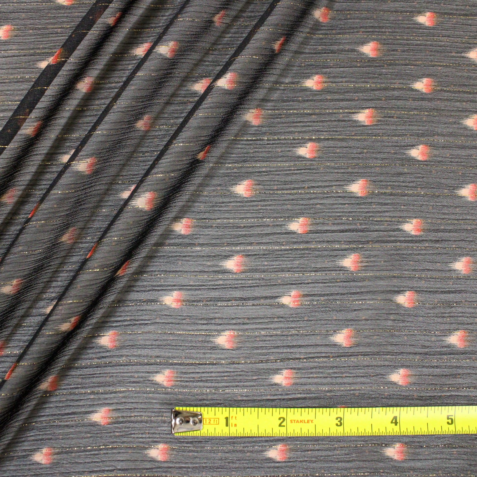 birds eye view of fabric with ruler showing the print repeats every 2 inches