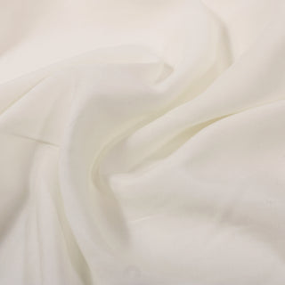 Close-up of smooth, white fabric with soft folds