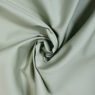 swirl of jade green fabric, demonstrating its stiff hand