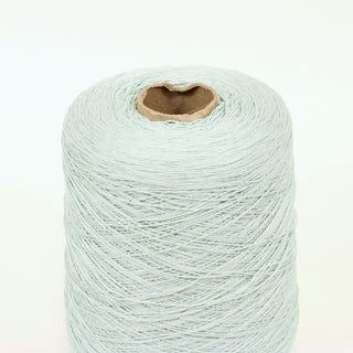 close-up of a cone of pale jade colored ultra-fine-gauge yarn
