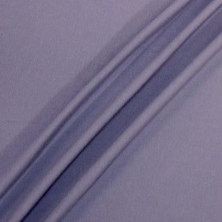 lavender colored interlock knit jersey fabric with three lines of draping on a surface to demonstrate its stretch and easy drape