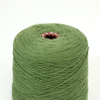 close-up of a cone of leaf green worsted-weight cotton yarn