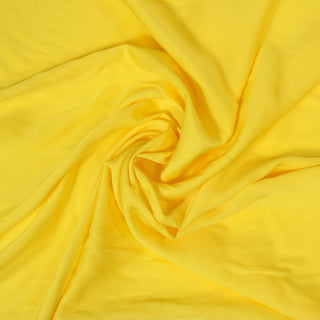 swirl of lemon yellow colored crepe back satin fabric