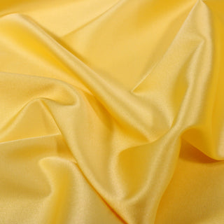 close-up of a yellow stretch-silk charmeuse fabric, detailing the surface shine