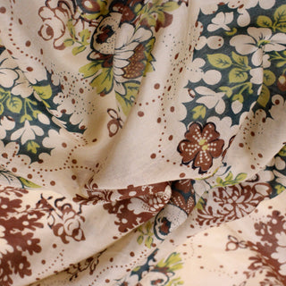 close-up of a very lightweight tan colored block printed earth tone botanical dot fabric