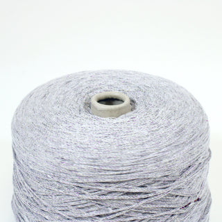 close-up of a cone of light grey sparkle core yarn