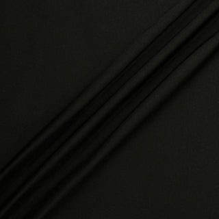 ripple of black satin fabric demonstrating the structured drape