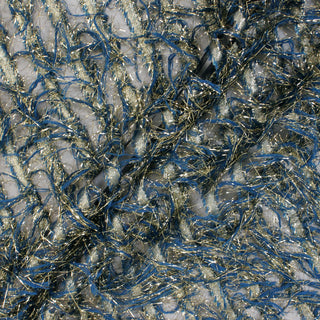 three diagonal lines draped of a blue and gold lurex and yarn fringe embellished black organza fabric