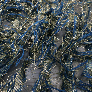 close-up of a black organza fabric with blue yarn and gold lurex threads fringing off of it in a stripe pattern