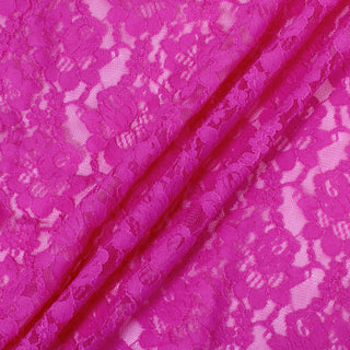 three diagonal lines draped of a pink stretch lace floral mesh fabric, demonstrating its sheer nature, drapeability, and lightweight hand